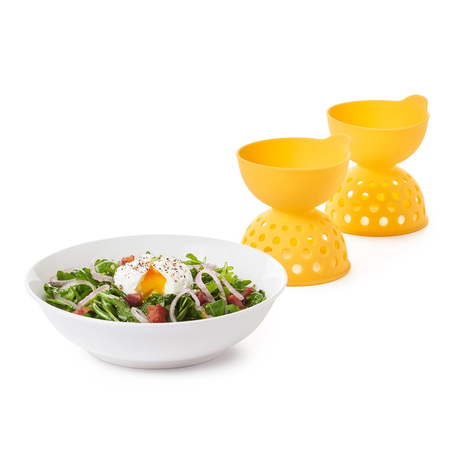 Zwei gelbe Silikon-Eier-Pochierer von OXO, ideal für die mühelose Zubereitung von pochierten Eiern in der Küche.
