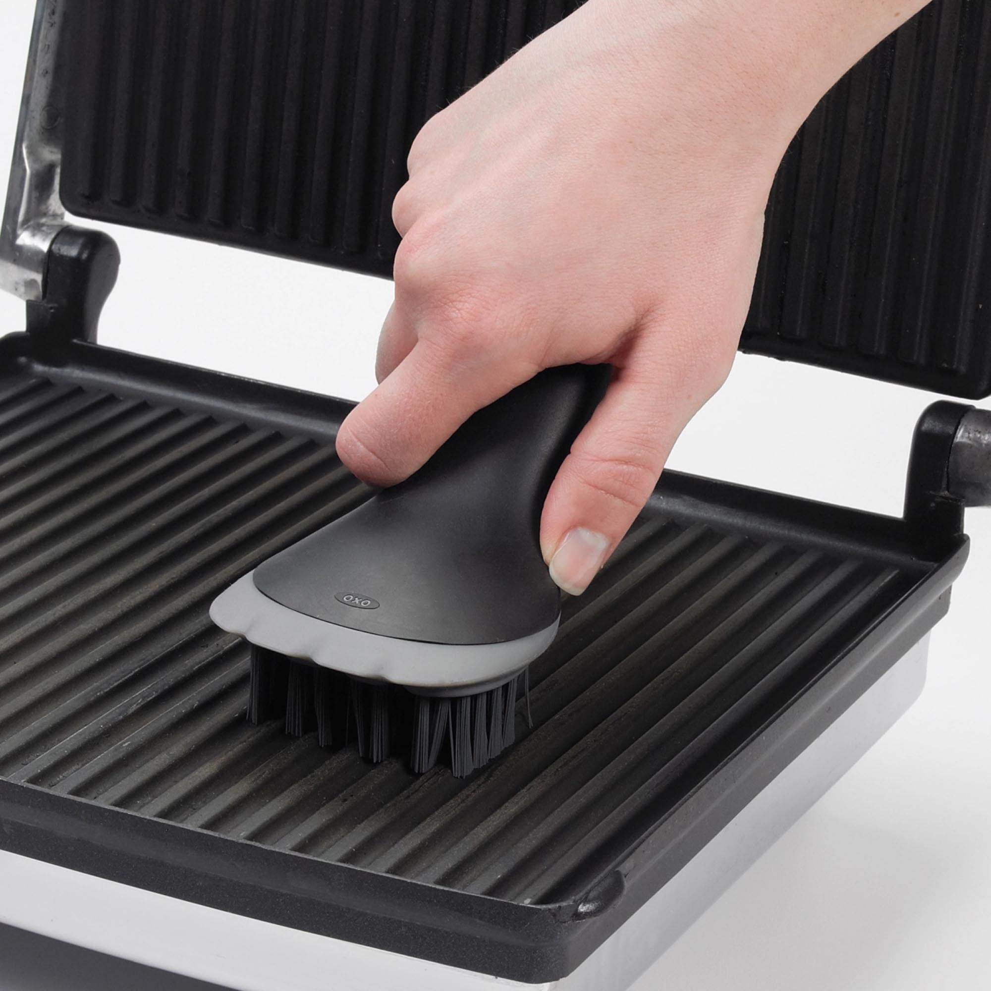 Praktische OXO Bürste für Elektrogrill und Sandwichtoaster in stilvollem Schwarz. Ergonomisches Design, langlebige Borsten und spülmaschinenfest für einfache Handhabung.