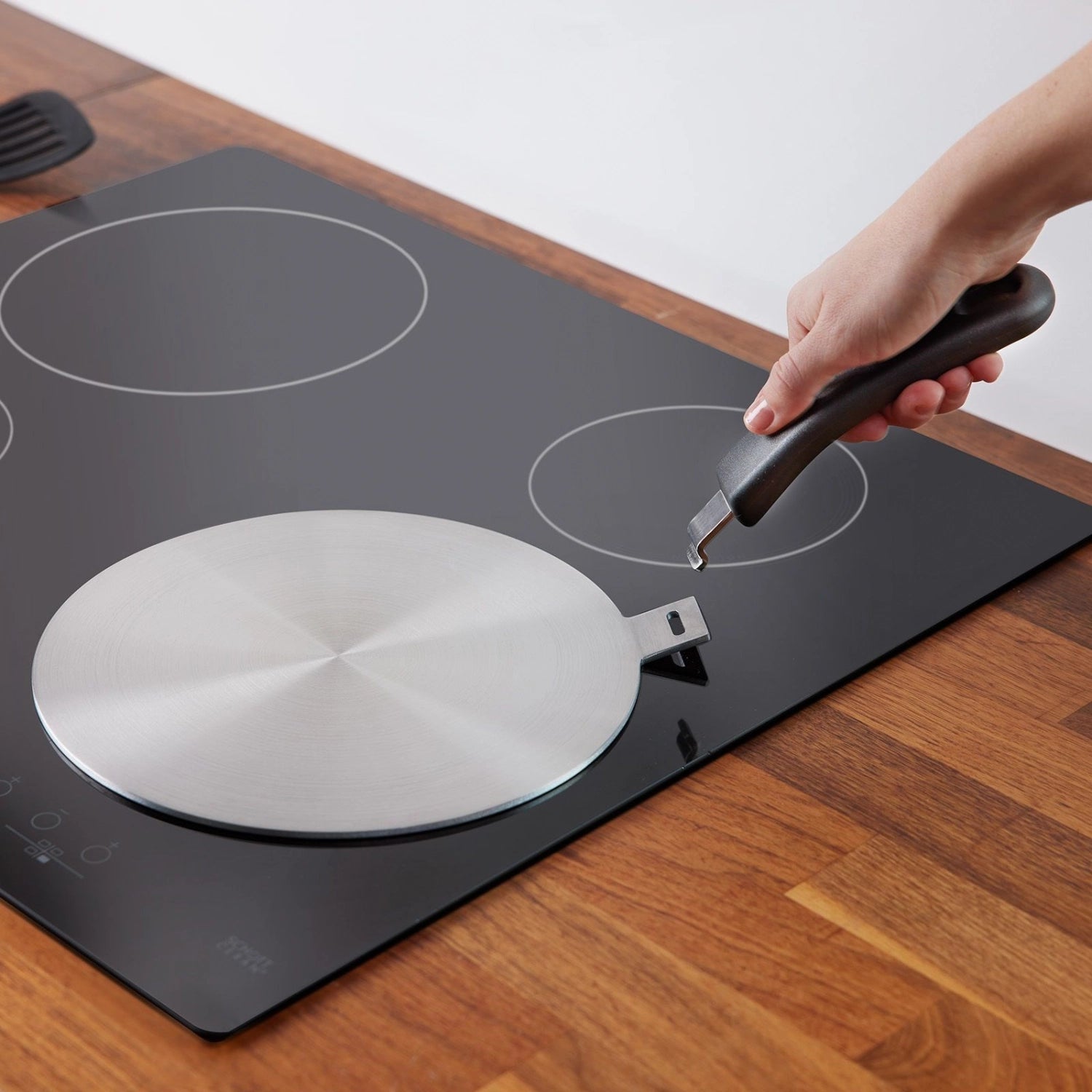 Induktionsadapterplatte von Westmark, Ø 24 cm, ermöglicht die Nutzung von nicht-induktiven Töpfen auf Induktionsherden, praktisch und funktional.