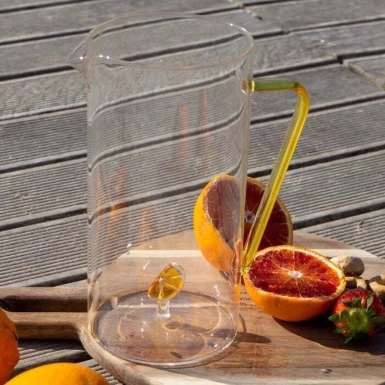 Elegante Karaffe aus hitzebeständigem Borosilikatglas mit 1,2 l Fassungsvermögen in leuchtendem Orange, ideal für stilvolle Getränkepräsentation.