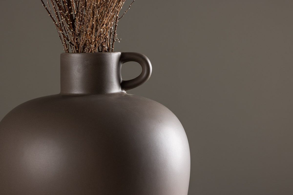 Beige Cent Vase von Venture Home aus Steinzeug mit wellenförmiger Struktur und zwei asymmetrisch angebrachten Griffen an den Seiten.