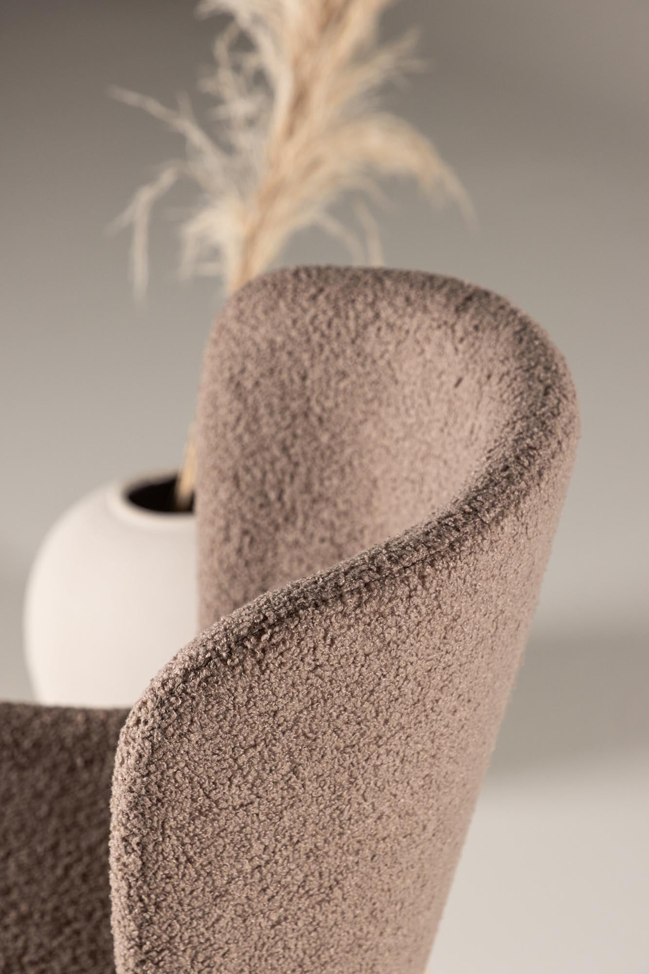 Modesto Stuhl: Stilvoller Komfort mit Teddy-Sitz und Stahlbeinen, ideal für jeden Essbereich.