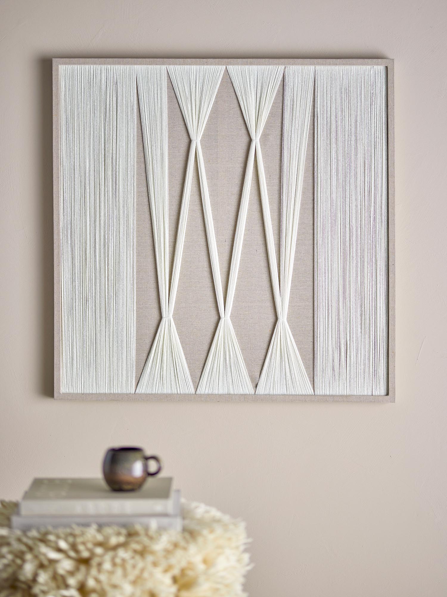 Die Didder Wanddekoration von Bloomingville vereint natürliche Baumwolle mit modernem Design, ideal für stilvolle, nachhaltige Wohnräume.