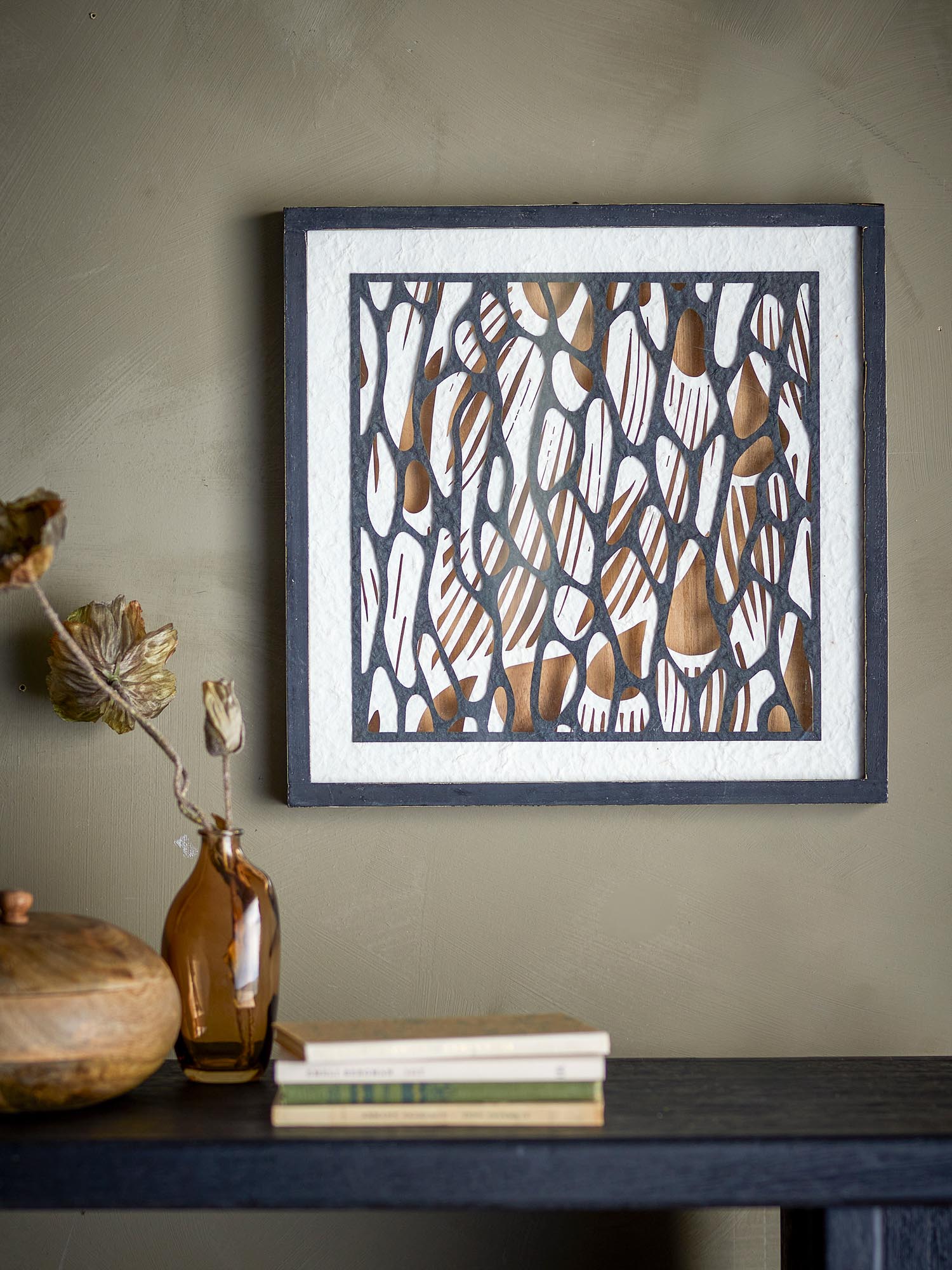 Einzigartige Scherenschnitt-Illustration in erdigen Tönen, gerahmt in elegantem schwarzem Kiefernholz.