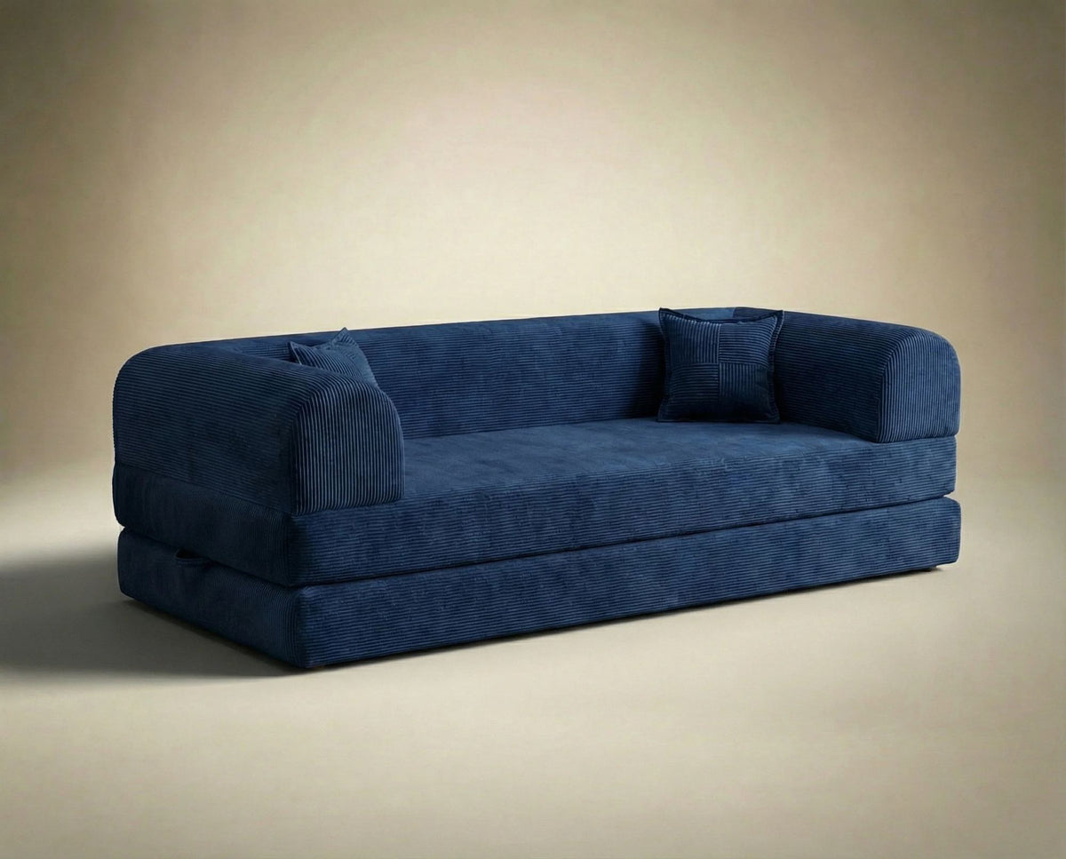 Marineblaues 3-Sitzer Schlafsofa Legom Eco von Hanah Home aus geripptem Cord-Plüschstoff mit zwei Kissen und niedrigem Rückenteil.