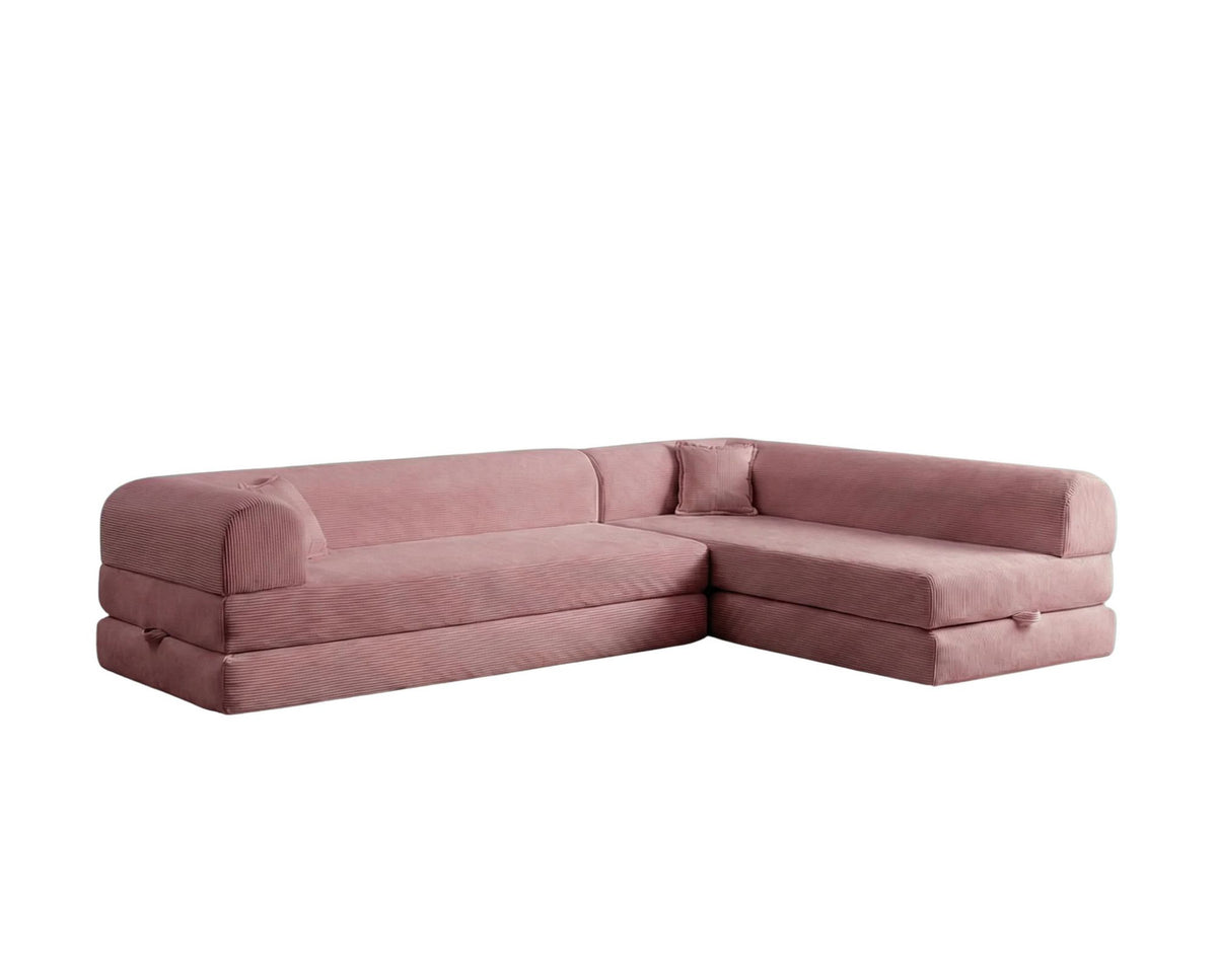 Rosa Ecksofa-Bett aus Cord-Plüschstoff mit vier Kissen, breiter Sitzfläche und niedriger Rückenlehne, als Sofa und Bett nutzbar.