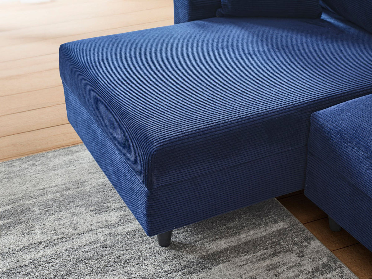 Marineblaues Ecksofa Flavia von Hanah Home mit Metallgestell, Polyesterbezug in Leinenstruktur und Kunststoffbeinen im Wohnraum.