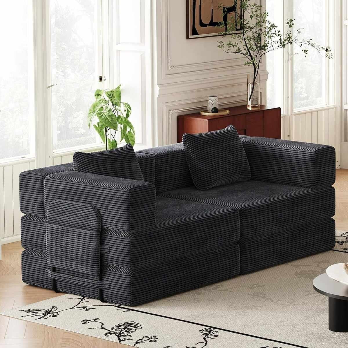 Schwarzes 3-Sitzer Schlafsofa aus Polyester-Leinen-Stoff mit zwei Kissen, schlichtes Design, ausgeklappt als Liegefläche sichtbar.