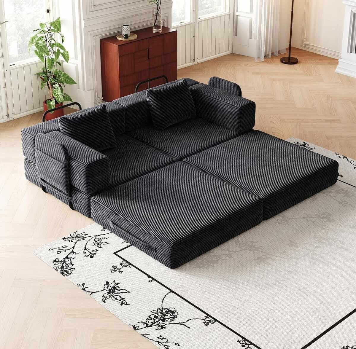 Schwarzes 3-Sitzer Schlafsofa aus Polyester-Leinen-Stoff mit zwei Kissen, schlichtes Design, ausgeklappt als Liegefläche sichtbar.