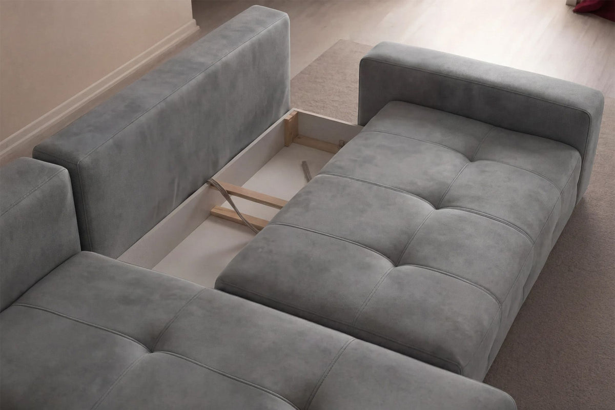 Graues Eck-Schlafsofa Magnum links aus Buchenholz und Polyesterbezug, mit Kunststoffbeinen, Stauraum und zwei losen Kissen auf der Sitzfläche.