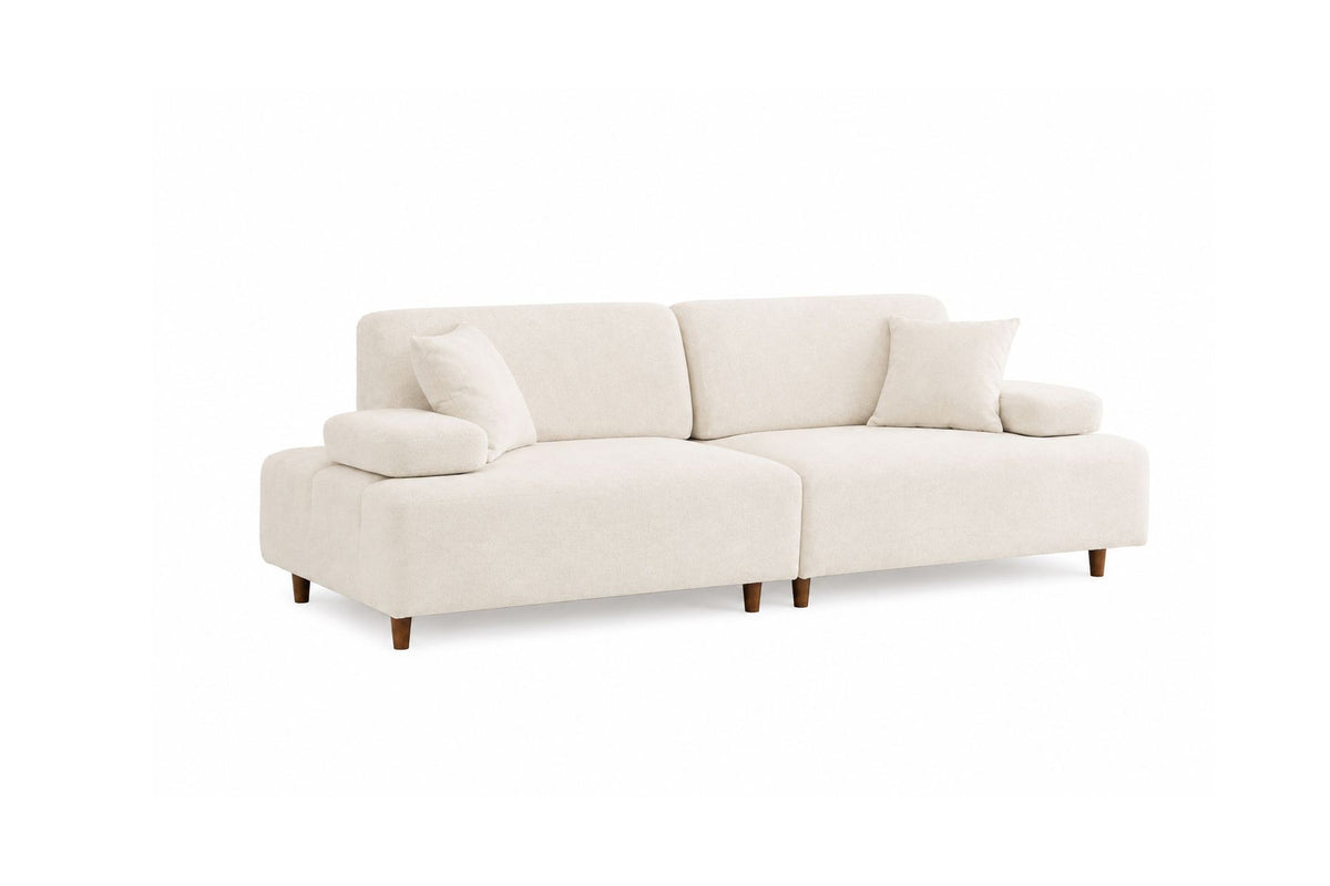 Cremefarbenes 3-Sitzer-Sofa Madlen von Hanah Home mit Polyesterbezug, Kunststoffbeinen und zwei Kissen auf Buchenholzgestell