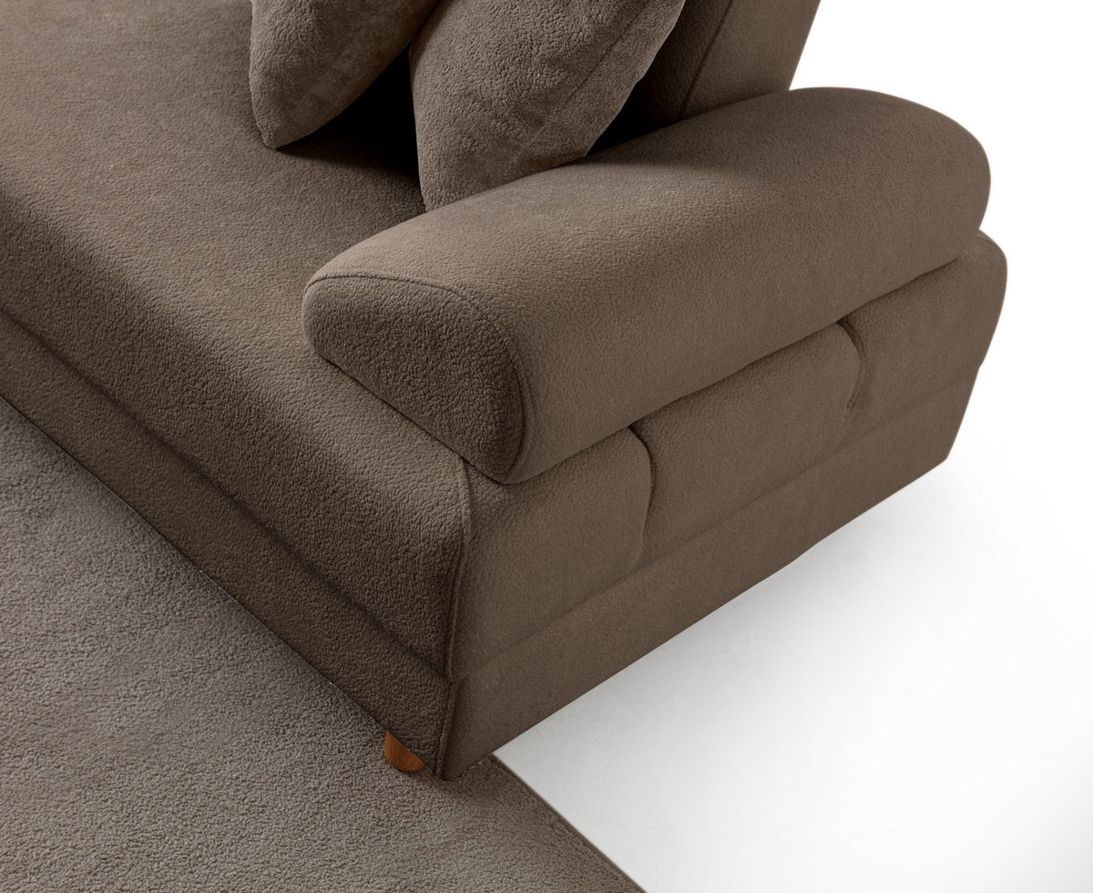 Braunes Eck-Schlafsofa Aries Modular M mit Coco-Boucle-Stoffbezug, Holzbeinen und sichtbarer Truhe, im Wohnzimmer aufgestellt.