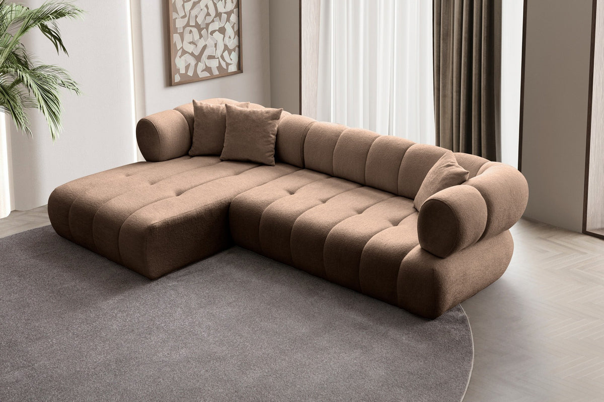 Ecksofa Petra links in Nerz-Farbton mit Boucle-Stoff-Bezug, Kunststofffüssen und drei losen Kissen, Ansicht von vorne.