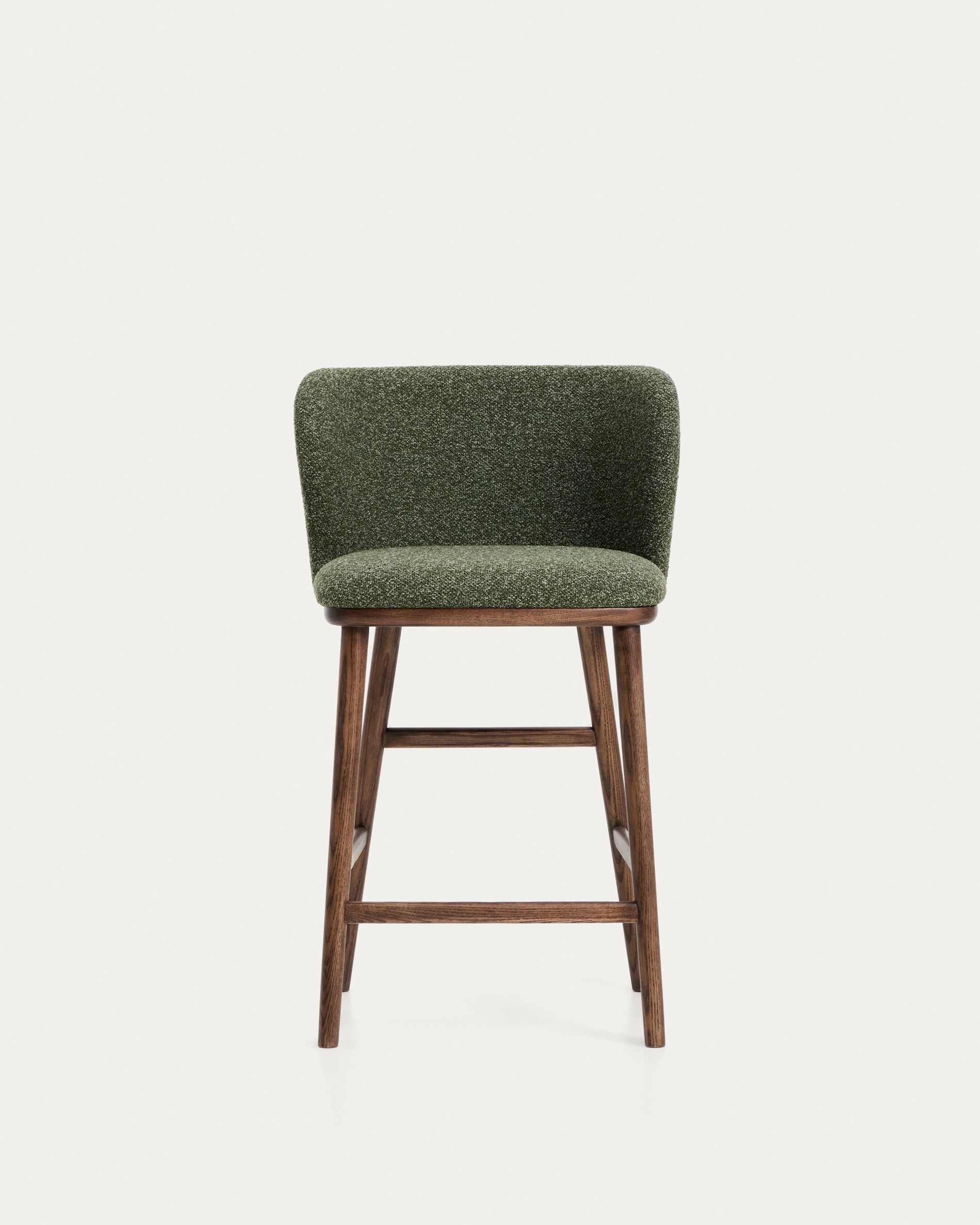 Eleganter Hocker Ciselia aus dickem, dunkelgrünem Chenille, ausgestattet mit stabilen Eschenholzbeinen in edlem Walnussholz-Finish, perfekt für stilvolle Bars.