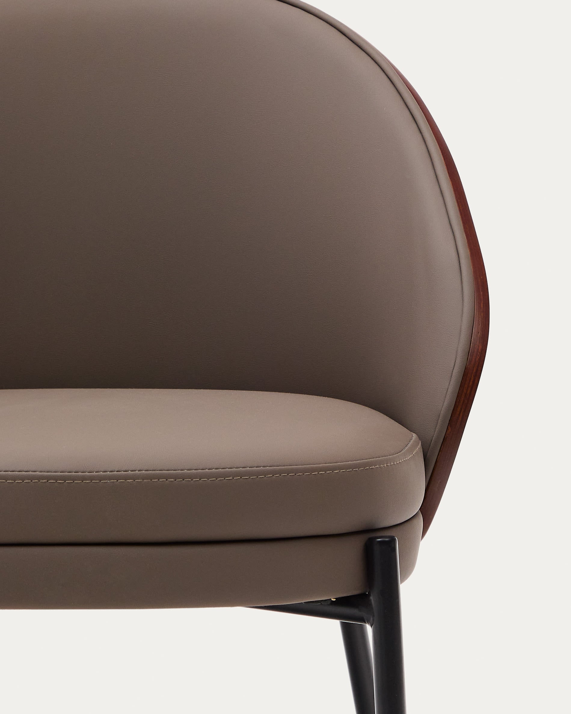 Stilvoller Eamy Stuhl aus braunem Kunstleder, veredelt mit Nussbaum-Eschenfurnier und robustem schwarzem Metallgestell – perfekt für jedes Zuhause.