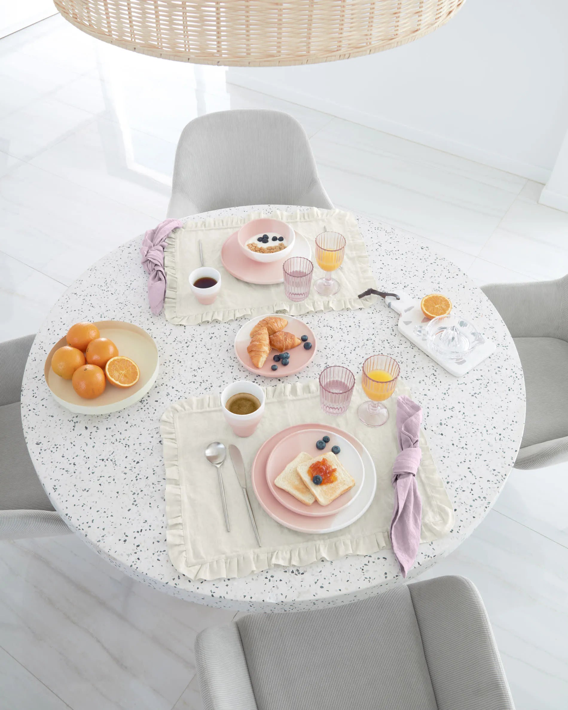 Moderner runder Tisch mit weißer Terrazzo-Platte und Akazienholzgestell, Ø 120 cm, ideal für stilvolle Essbereiche, von Kave Home.