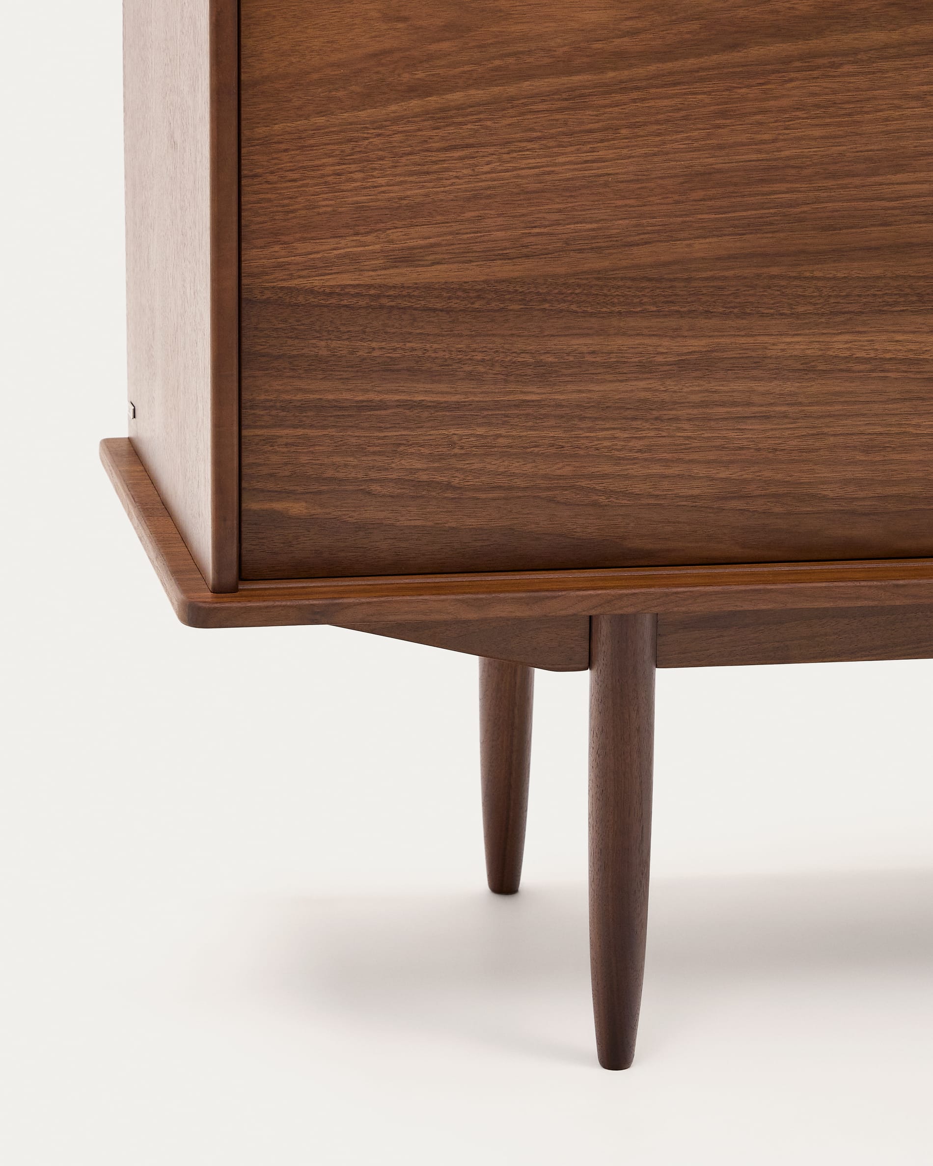 Entdecken Sie das Carolin Sideboard von Kave Home: Ein stilvolles Möbelstück aus edlem Nussholzfurnier mit viel Stauraum und charmantem Retro-Design.