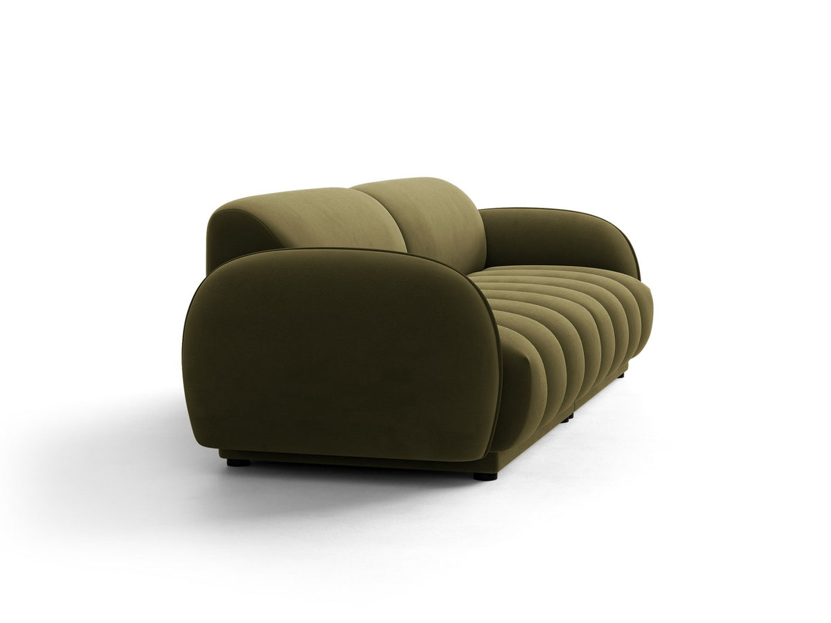 Vierersofa Bilbao mit hellbeigem Samtbezug, schwarzen Kunststoffbeinen und klarer, gerader Linienführung, fotografiert freistehend im Raum.