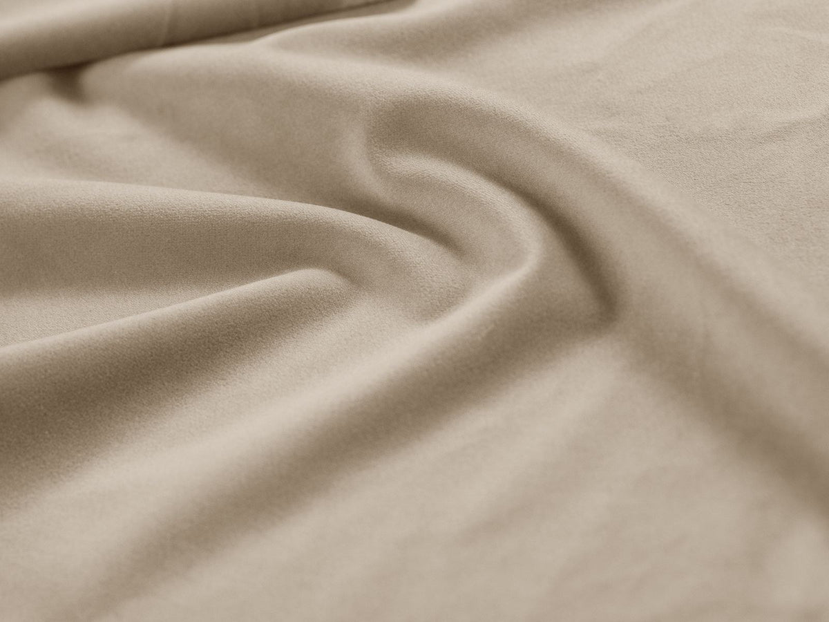 Drehsessel Savona mit samtigem Stoffbezug in Light Beige, gepolsterter Rückenlehne und stoffbezogenen Beinen auf Kiefernholzgestell.