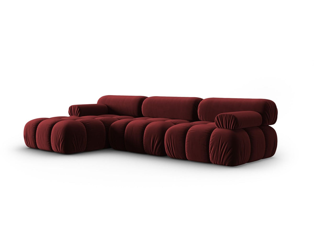 Modulares Ecksofa mit rosa Samtstoff, schwarzen Kunststoffbeinen und gepolsterter Récamiere, Ansicht von vorne links.