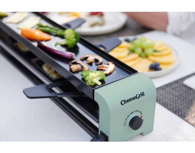 STÖCKLI CheeseGrill 2 Connect in Mint Green mit zwei antihaftbeschichteten Pfännchen, wendbarer Aluguss-Grillplatte und Kunststoffspachteln auf hellem Untergrund