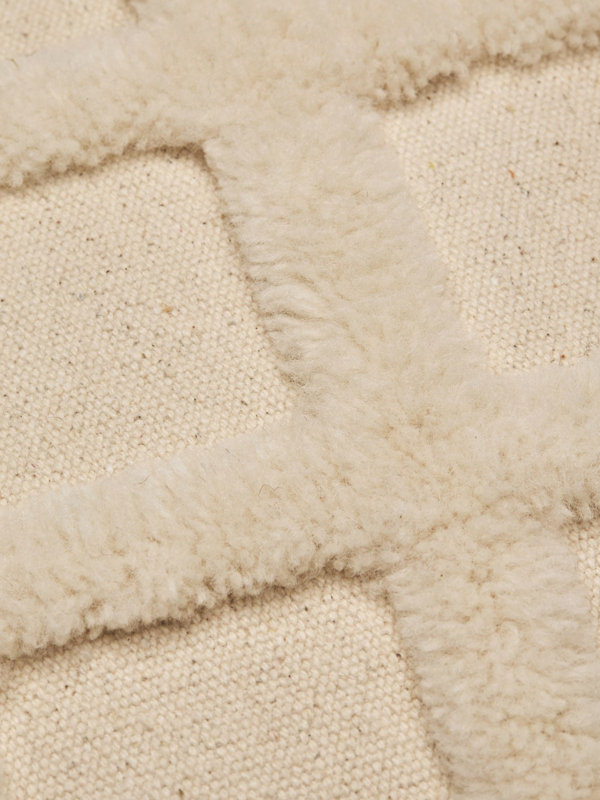 Quadratisches Dekokissen Norte Grid von Ferm Living in Off-White, handgetuftet aus Wolle und Baumwolle mit grafischem Gittermuster.
