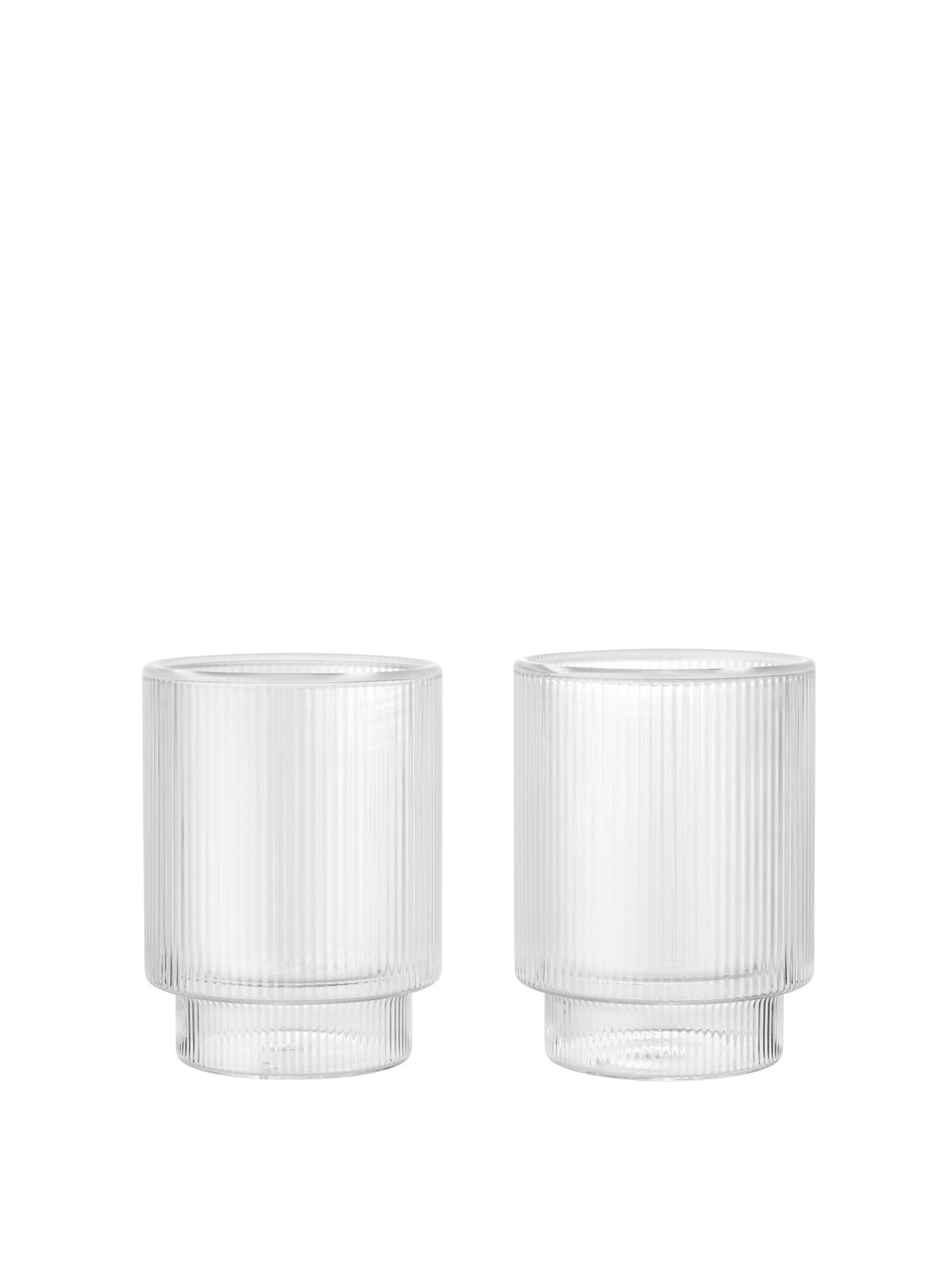 Zwei klare, doppelwandige Ripple Thermogläser von Ferm Living mit geriffelter Oberfläche aus mundgeblasenem Glas, nebeneinander auf hellem Untergrund.