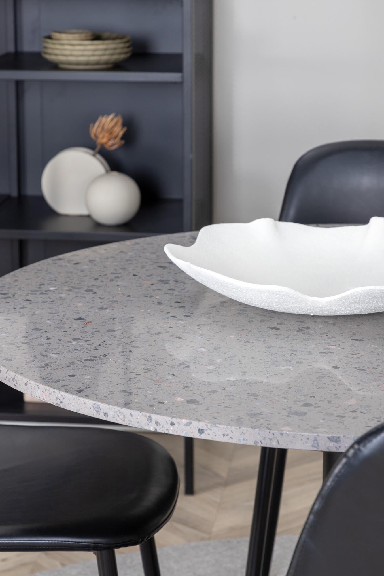 Elegantes Esszimmerset mit runder Tischplatte und luxuriösen Samtstühlen. Ideal für gesellige Abende und modernes Wohnen.