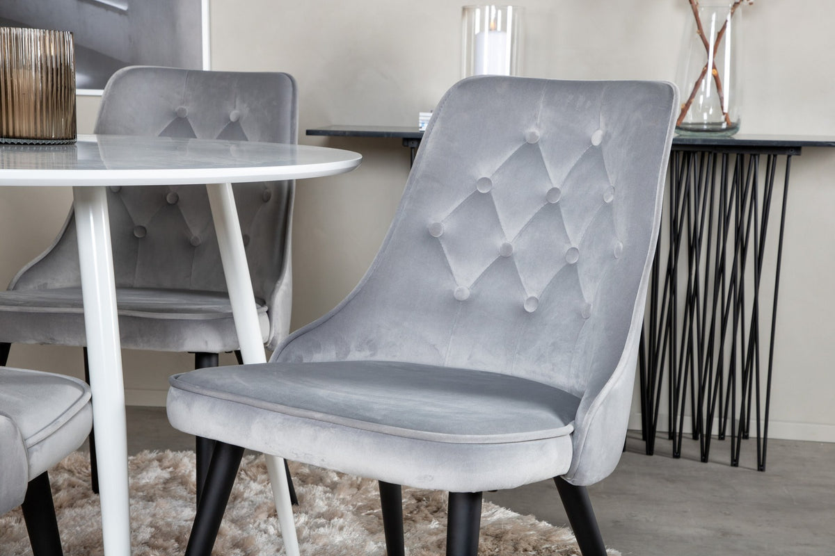 Plaza Bartischset: Hoher Esstisch mit weisser MDF-Tischplatte auf Stahlbeinen, dazu Velvet Deluxe Stühle mit schwarz pulverbeschichtetem Gestell.