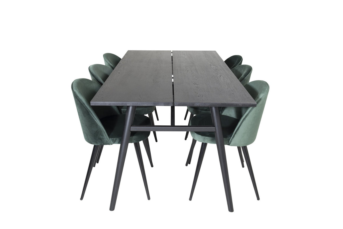 Rechteckiger Esstisch mit schwarzer Eichenplatte und Stahlbeinen, kombiniert mit zwei grünen Polsterstühlen aus Stahl mit schwarzer Pulverbeschichtung.