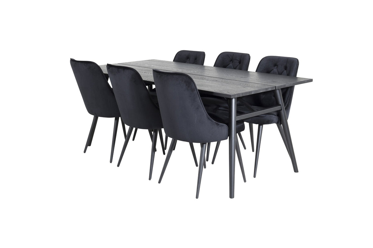 Rechteckiger Esstisch mit schwarzer Eichenplatte und Stahlbeinen, daneben zwei schwarze, gepolsterte Esszimmerstühle von Venture Home.