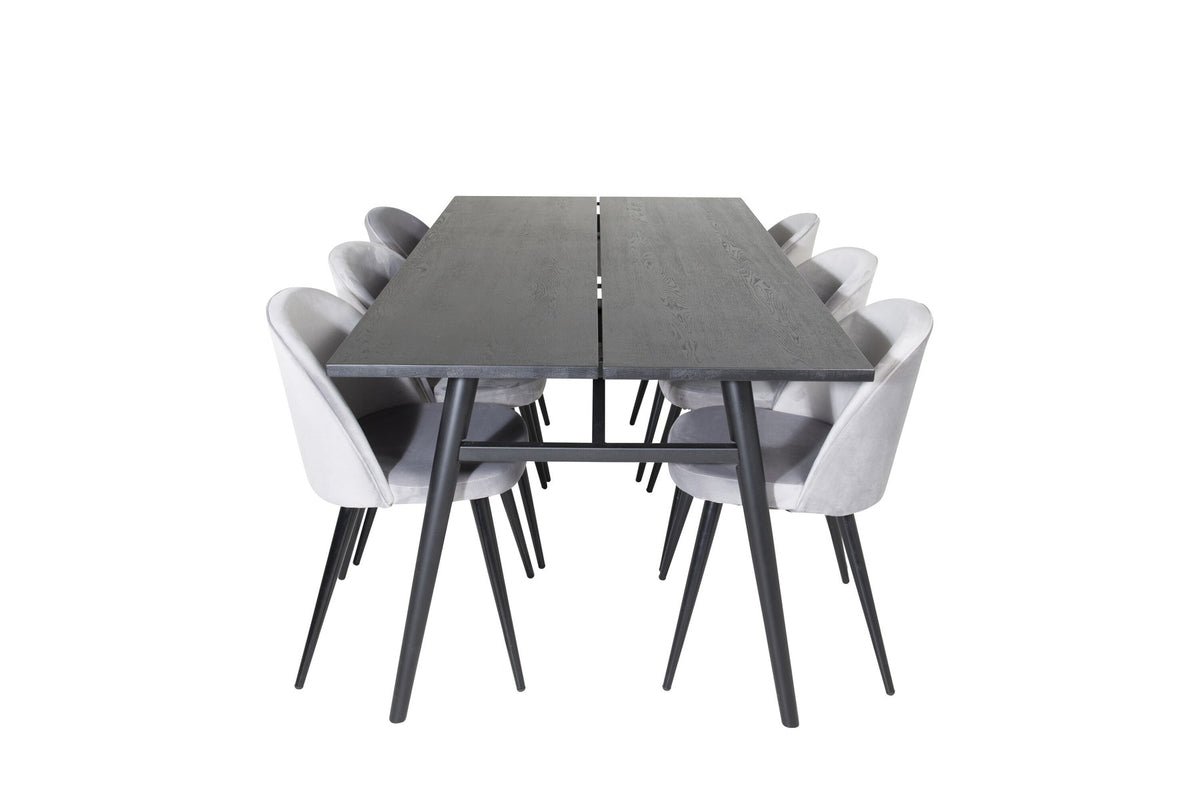 Rechteckiger Esstisch mit schwarzer Eichenplatte und Stahlbeinen, dazu zwei graue Stühle mit Stahlgestell aus dem Sleek & Velvet Set.