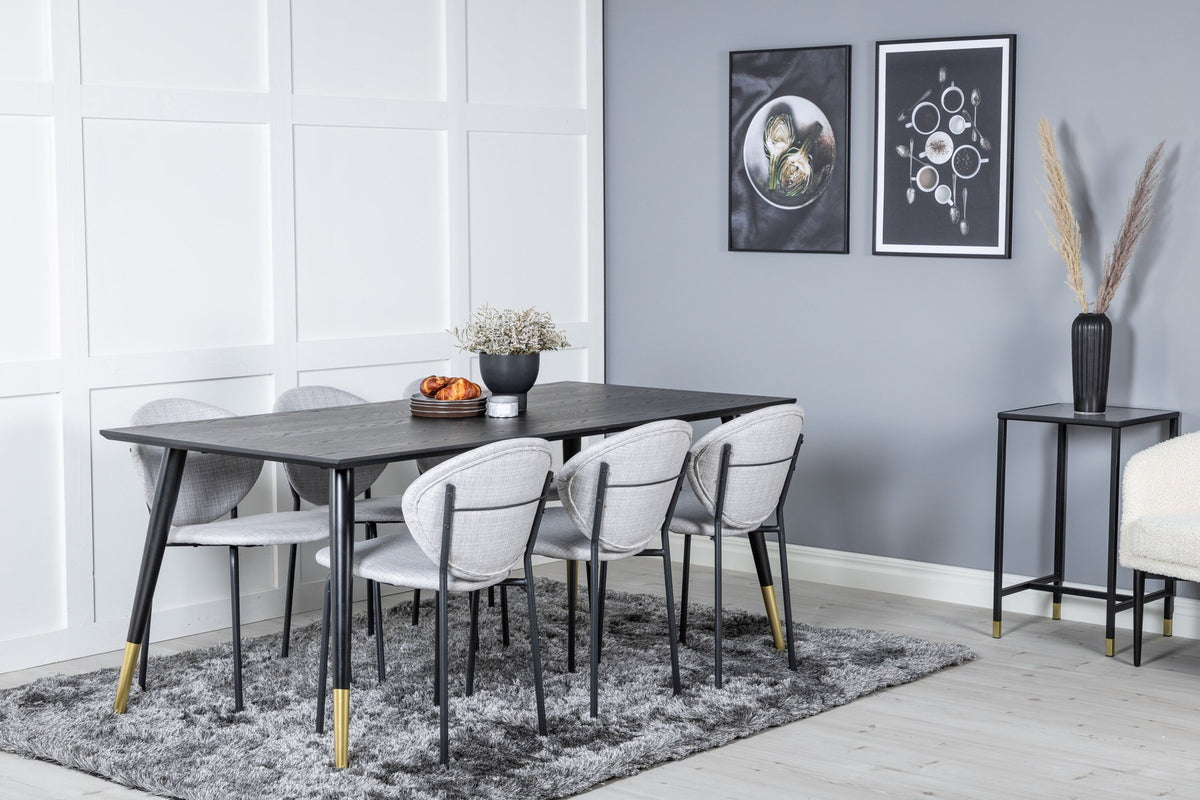 Schwarzes Esszimmerset Dipp mit Vault Stühlen: Tisch mit MDF-Furnierplatte und Stahlbeinen, Stühle mit Polsterbezug und Stahlgestell.