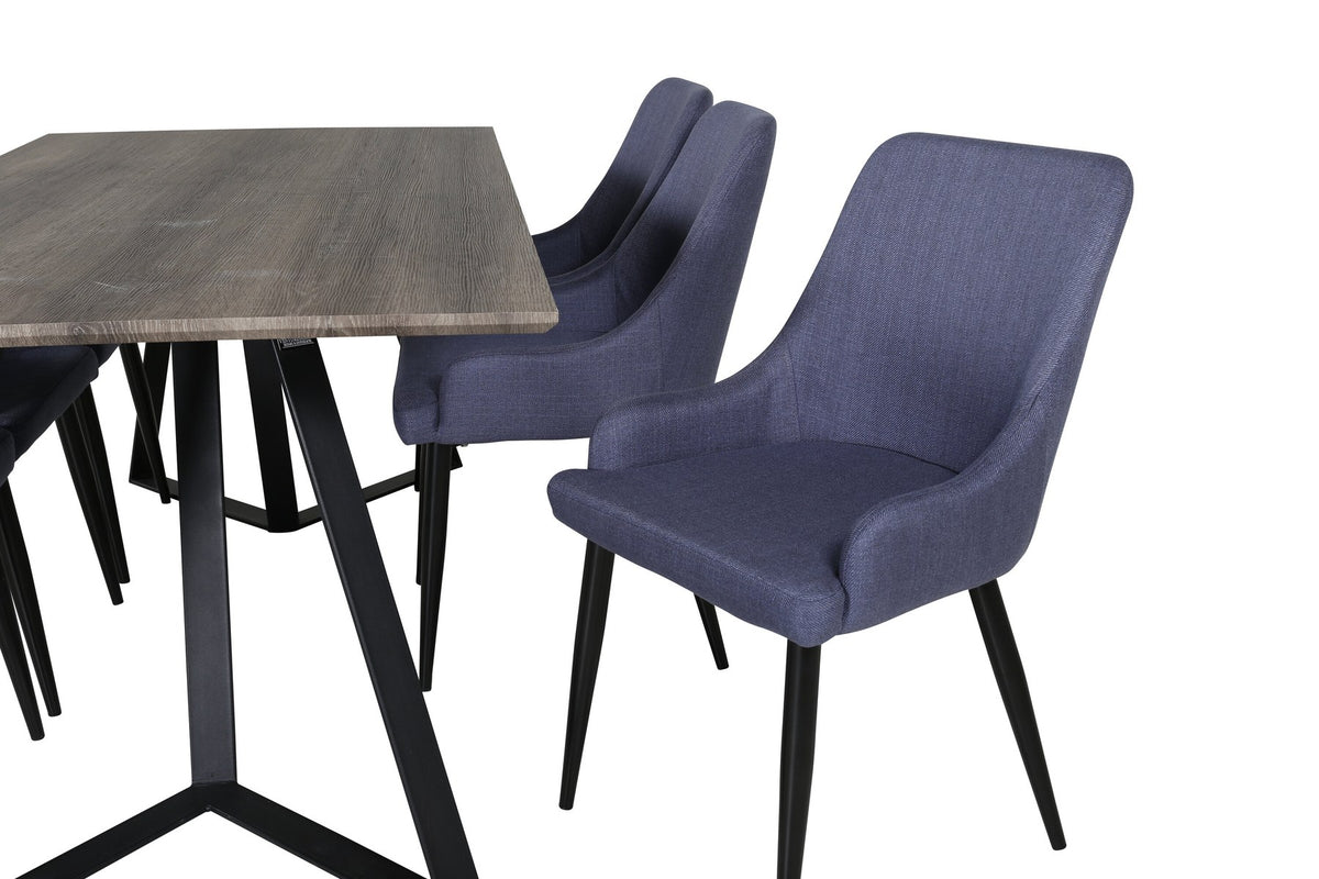 Zwei blaue Esszimmerstühle mit Stahlgestell und schwarz pulverbeschichteter Oberfläche neben einem rechteckigen MDF-Esstisch mit Stahlbeinen.
