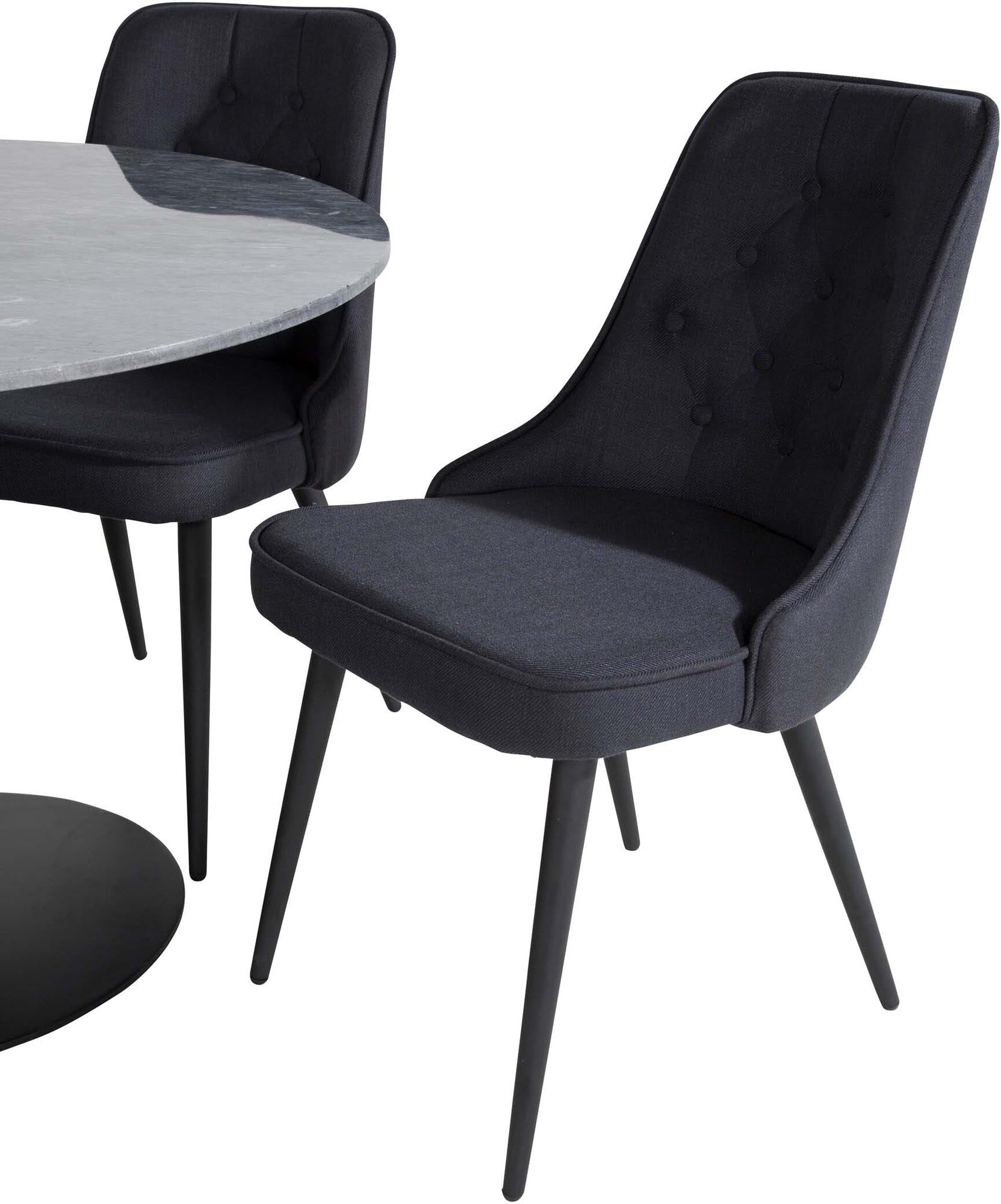 Stilvolles Esszimmerset mit rundem Tisch und vier edlen Samtstühlen.