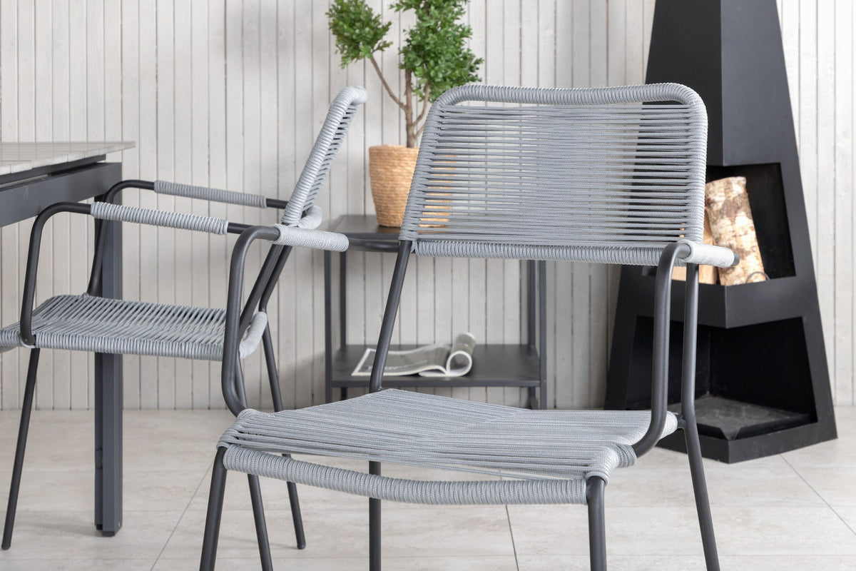 Rechteckiger Aintwood-Esstisch in Schwarz mit Stahlbeinen und zwei grauen Aintwood-Aluminium-Stühlen mit Pulverbeschichtung im Garten.