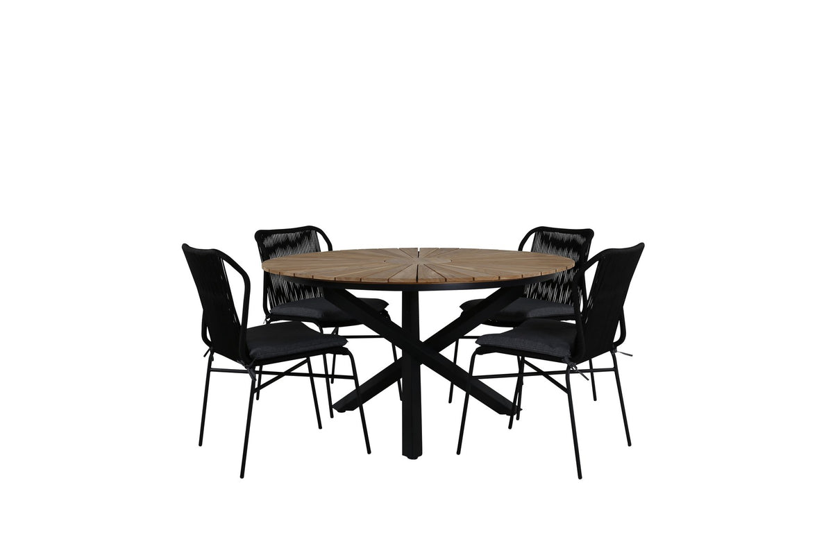 Vier schwarze Esszimmerstühle mit Aluminiumgestell und Polyesterbezug neben rundem Teak-Esstisch mit Stahlbeinen, Durchmesser 140 cm.