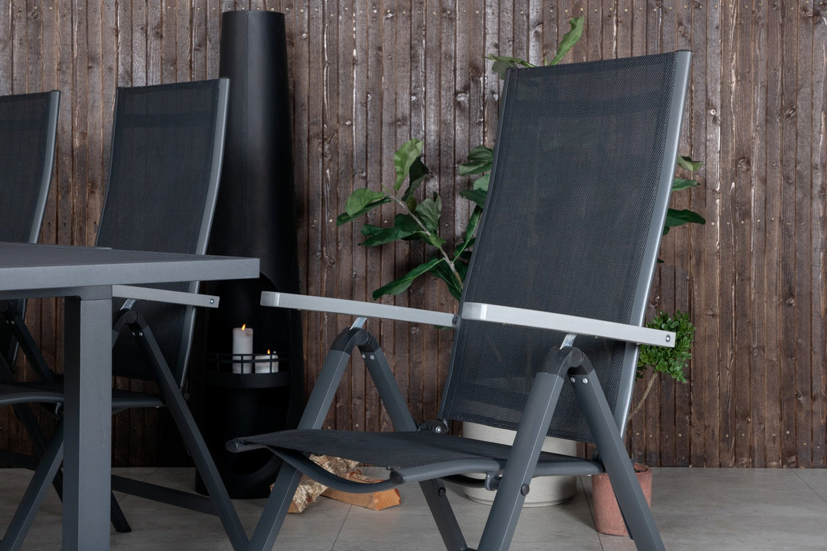 Zwei schwarze Aluminium-Positionsstühle und ein rechteckiger, ausziehbarer Aluminium-Gartentisch in Schwarz mit glatter Oberfläche.
