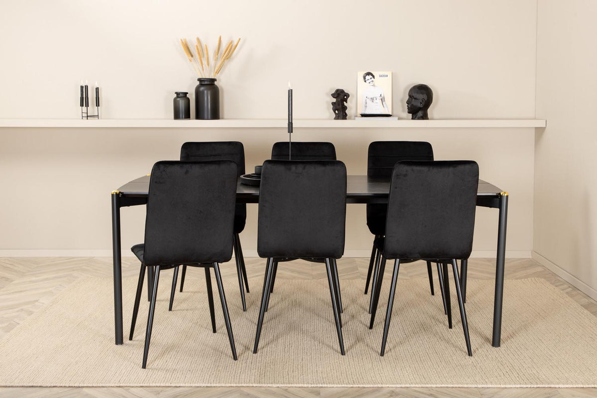 Esszimmerset Pelle mit schwarzem MDF-Tisch mit Furnier und sechs Windu Stühlen aus schwarzem Samt mit Metallgestell und Kissen.
