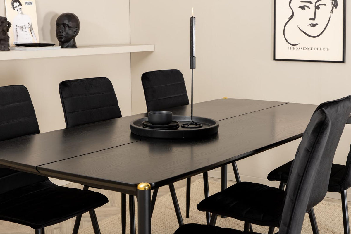Esszimmerset Pelle mit schwarzem MDF-Tisch mit Furnier und sechs Windu Stühlen aus schwarzem Samt mit Metallgestell und Kissen.
