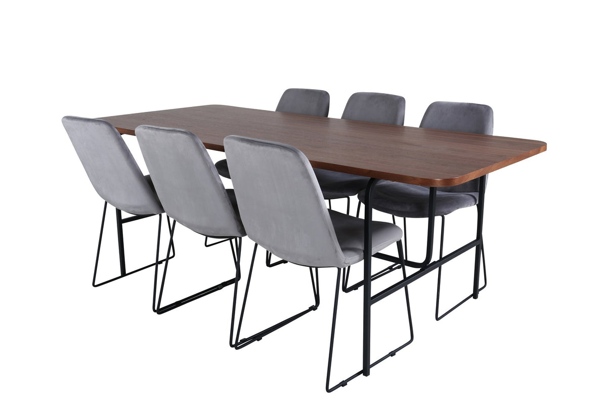 Rechteckiger Esstisch mit Nussbaum-Tischplatte aus MDF und Furnier, Stahlgestell, umgeben von sechs grauen Samtstühlen mit schwarzem Stahlgestell.