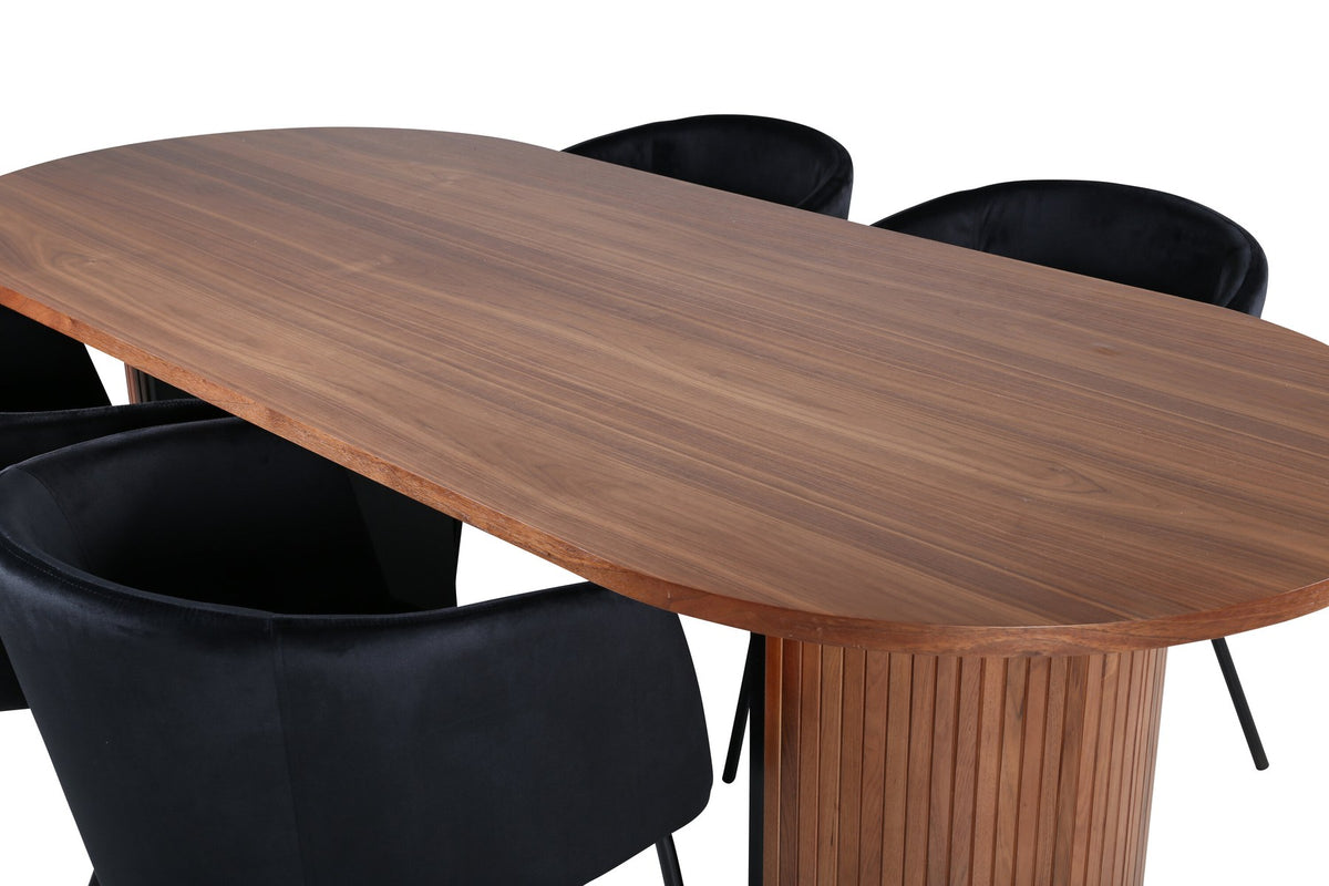 Ovaler Esstisch aus Nussbaum-MDF mit Furnier und vier schwarzen Esszimmerstühlen mit Samtsitz und schmalen Eisenbeinen von Venture Home.