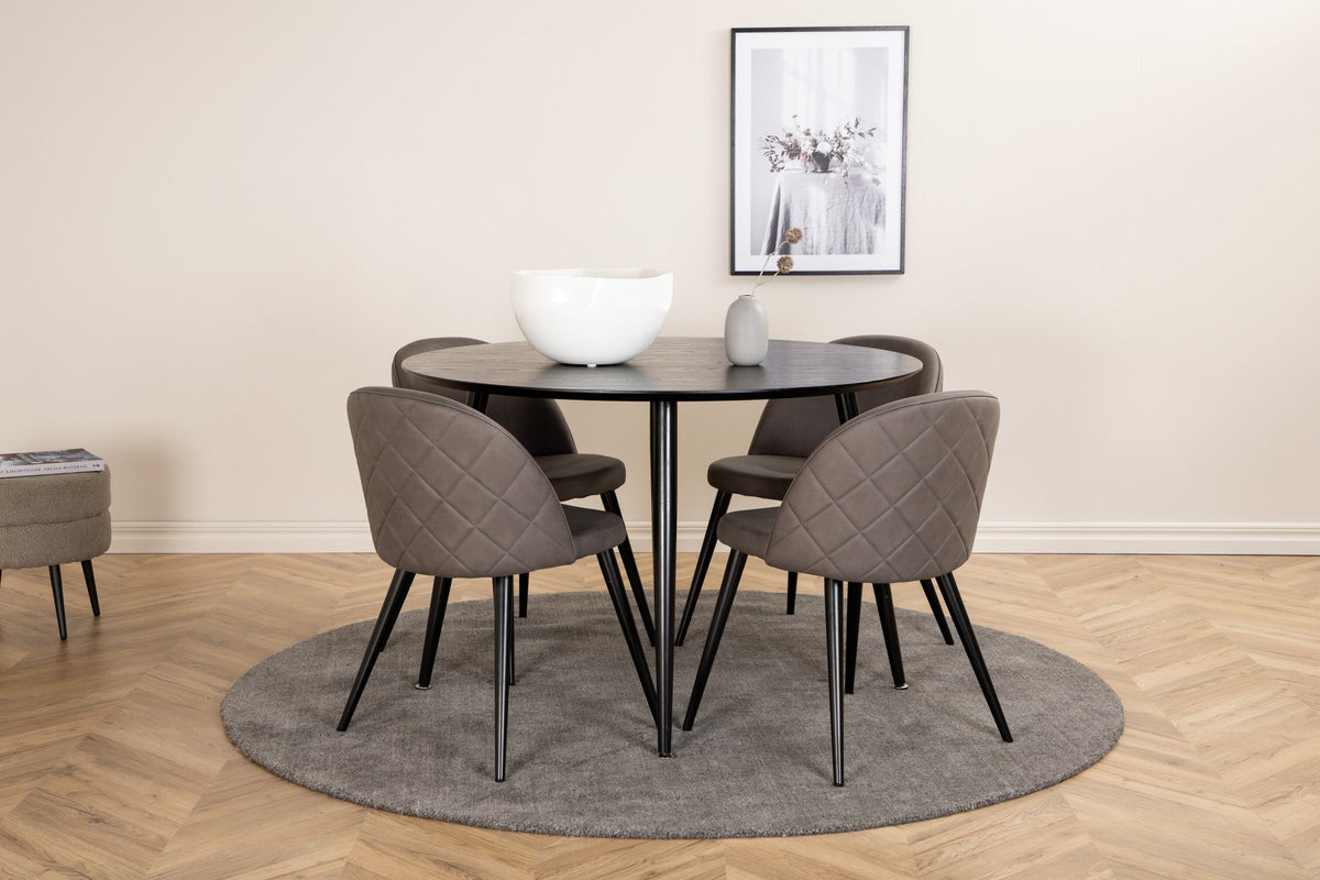 Rundes Dipp Esszimmerset: Esstisch ⌀115 cm mit schwarzem Furnier und schwarzen Beinen, dazu vier Velvet-Stühle mit schwarz-grauem Mikrofaserbezug.