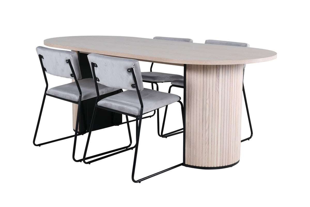 Zwei graue Esszimmerstühle mit schmalen schwarzen Beinen neben ovalem Esstisch mit MDF-Platte in Whitewash, Grösse 200x90 cm.