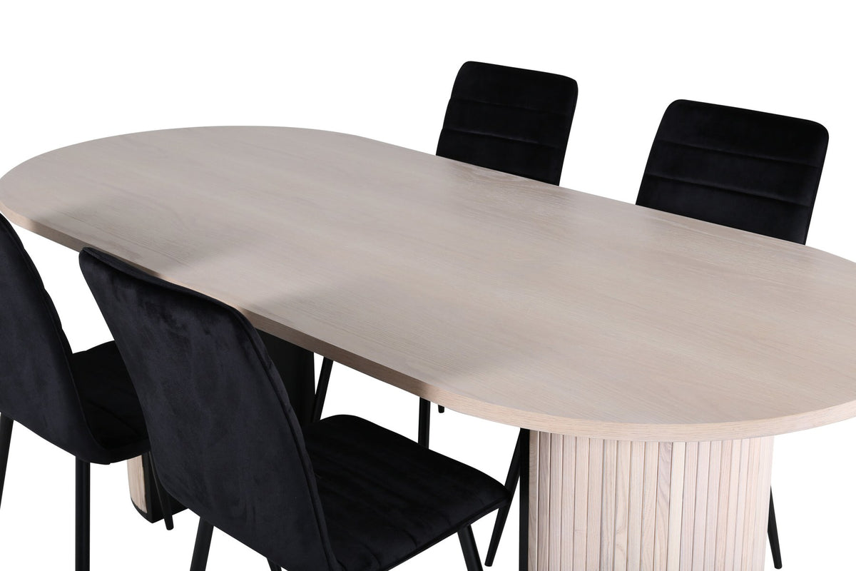 Ovaler Esstisch aus MDF in Whitewash mit zwei schwarzen Esszimmerstühlen, schmalen Eisenbeinen und schwarzer Pulverbeschichtung.