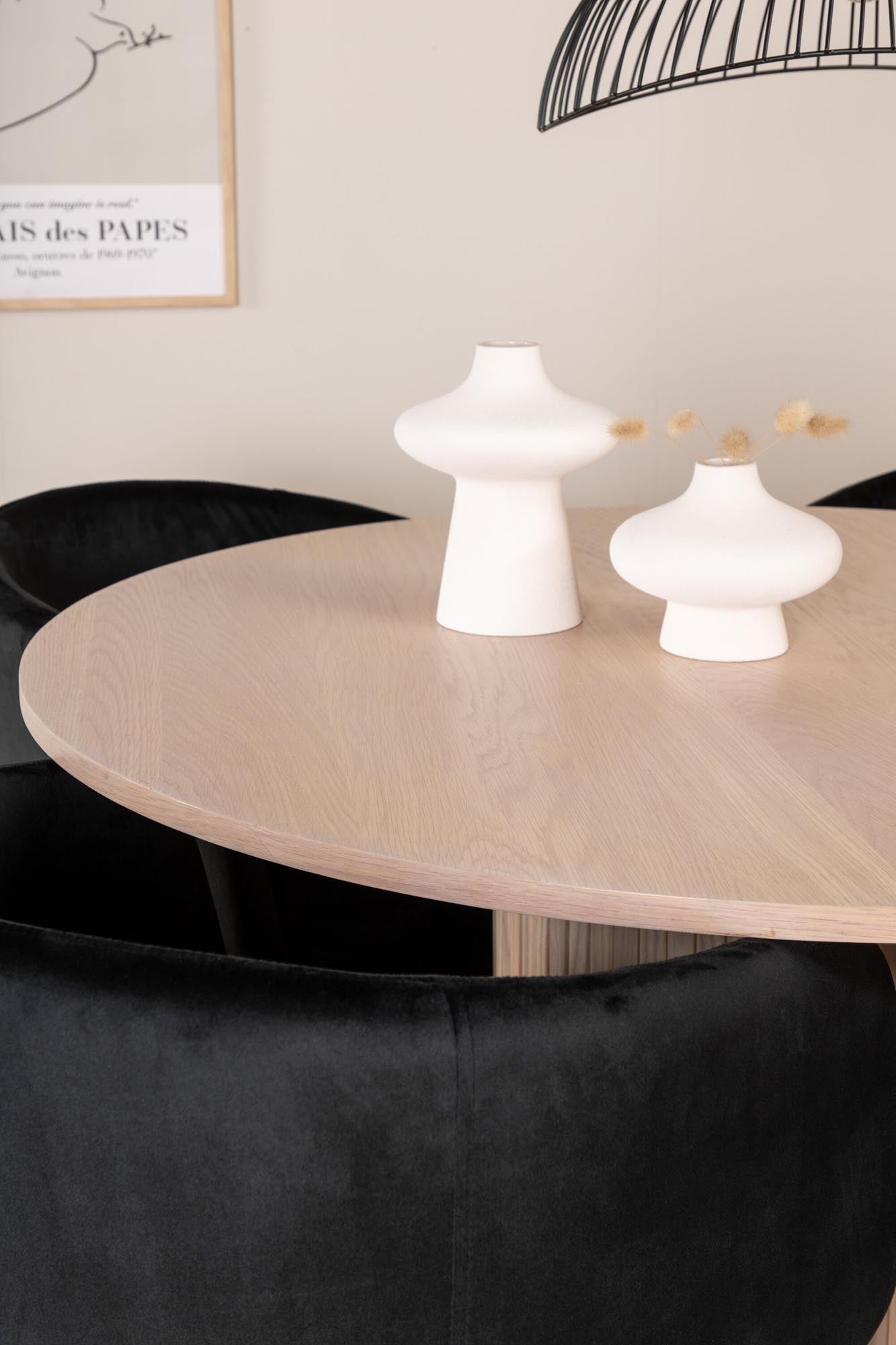 Modernes Esszimmerset Bianca: Stilvoller runder Tisch mit 4 bequemen Samt-Stühlen, ideal für gesellige Abende und elegantes Ambiente.