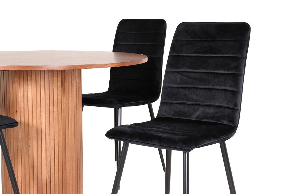 Rundes Esszimmerset Bianca mit schwarzer MDF-Tischplatte, Rippengestell und vier Windu-Stühlen mit schwarzem Samtbezug und Stahlbeinen.