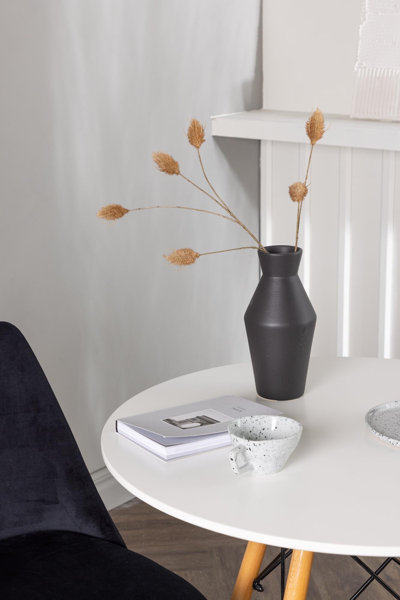 Elegantes Danburi Esszimmerset: Weisser MDF-Tisch, Buchenholzbeine, schwarze Samtstühle. Perfekt für stilvolle Räume.