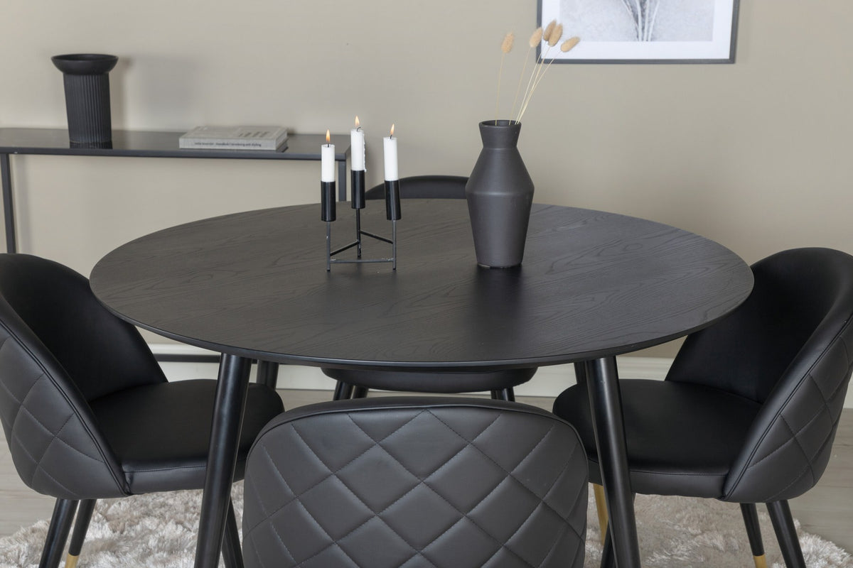 Rundes Dipp Esszimmerset: Esstisch ⌀115 cm mit schwarzem Furnier und schwarzen Beinen, dazu vier Velvet-Stühle mit schwarz-grauem Mikrofaserbezug.