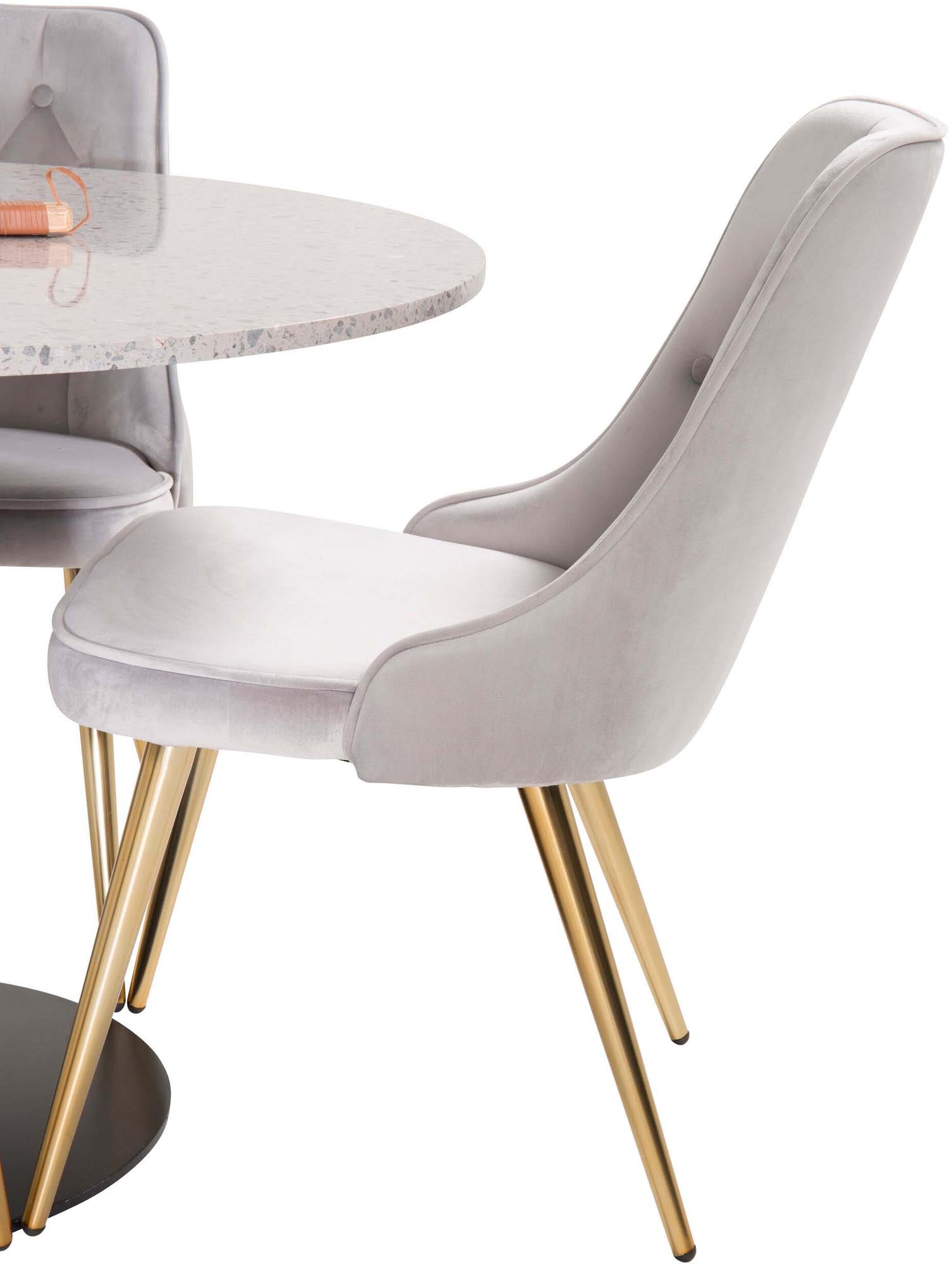 Stilvolles Esszimmerset mit luxuriösen Samtstühlen und elegantem Tisch für gesellige Runden und festliche Anlässe.